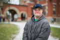 Alt text: UNH-4U student Andrew Strzykalski, one of four students in the inaugural cohort of the UNH-4U program. Andrew is wearing a gray jacket, baseball cap, and is smiling.